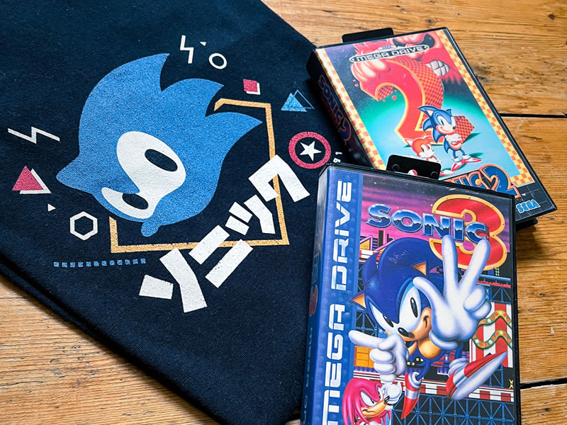Image of Sonic shirt, with two Sonic classic games on the Mega Drive